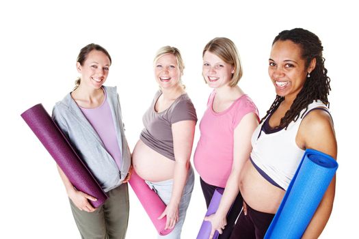 Ready for their yoga class. Pregnant friends standing together and holding their yoga mats while isolated on white