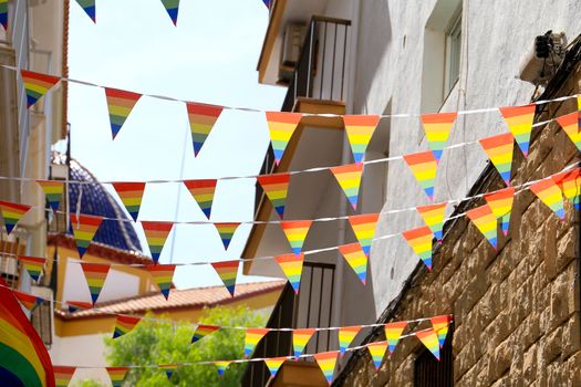 Streets and facades adorned with colorful rainbow flags for The Gay Pride in Benidorm