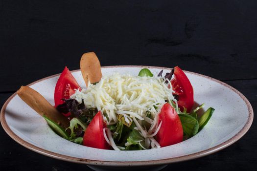 healthy eating, dieting, vegetarian kitchen and cooking concept - close up of vegetable salad bowl at home. High quality photo