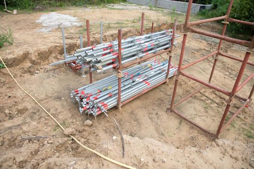 strong metal scaffolding at the construction site of a new house, the beginning of wooden structures around a metal frame. High quality photo