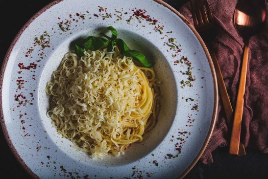 Pasta spaghetti with zucchini basil cream and cheese. Top view on grey stone table. Vegetarian vegetable pasta. Zucchini noodles. High quality photo