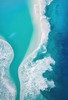 Beach and waves from above. ater background from the top. Summer attacks from the air. Aerial view of a blue ocean