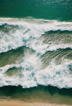 Beach and waves from above. ater background from the top. Summer attacks from the air. Aerial view of a blue ocean