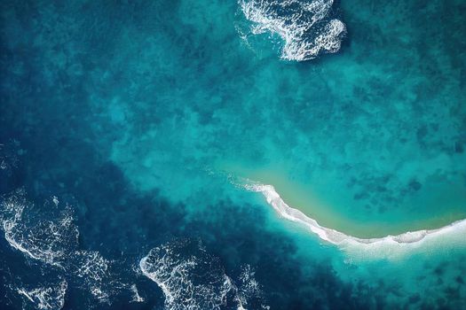 Beach and waves from above. ater background from the top. Summer attacks from the air. Aerial view of a blue ocean