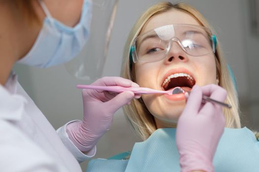 Close up of a woman having dental treatment performed by experienced dentist