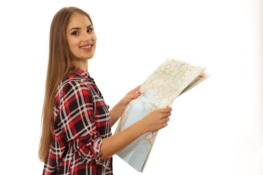 Young beautiful charming female traveler smiling to the camera holding a map isolated copy space. Gorgeous happy woman tourist looking for destination on a map. Travelling, tourism, navigation