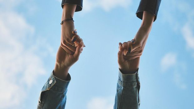 young male couple holding hands standing on their way together.