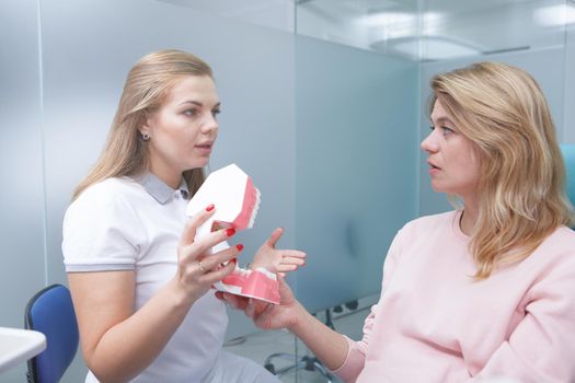 Mature woman getting dental consultation at dentists office