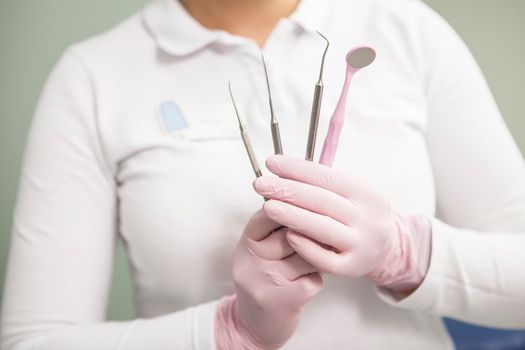 Dental tools in the hands of female dentist