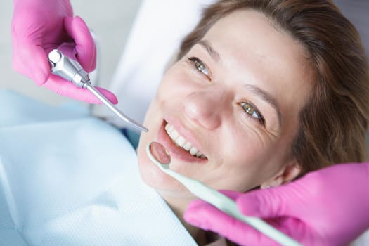 Close up of a cheerful mature woman smiling during dental checkup at the clinic