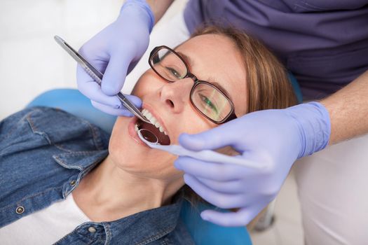 Close up of a mature female patient having dental treatment at the clinic