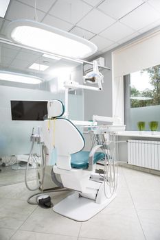 Vertical shot of empty dental chair at dentists office