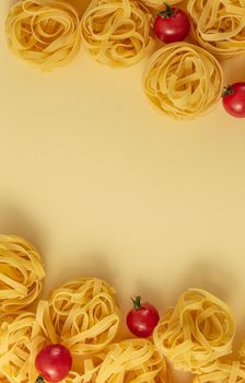 Minimal food pattern tagliatelle and tomatoes, light yellow pastel background. Traditional Italian pasta in pop art style. Pasta and tomatoes, Italian cuisine concept. Top view, flat lay, copy space