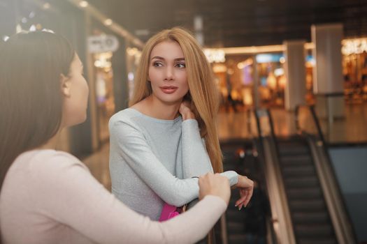 Gorgeous woman talking to her friend at the shopping mall