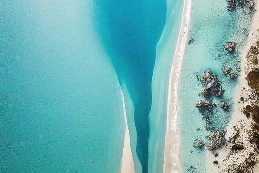 Beach and waves from above. ater background from the top. Summer attacks from the air. Aerial view of a blue ocean