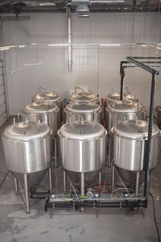 Vertical shot of beer tanks and beer production equipment at microbrewery