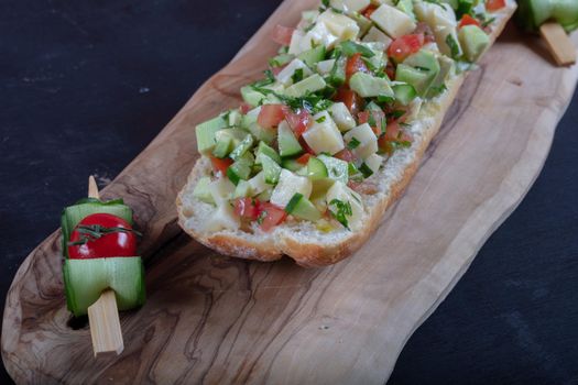 Bruschetta with tomatoes, mozzarella cheese and basil on a old rustic table. Traditional italian appetizer or snack, antipasto. High quality photo