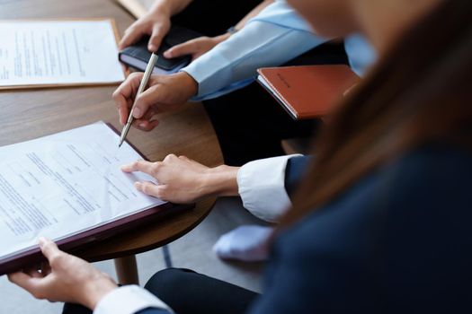 Couples sign important documents with insurance agents.