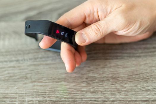 Close up shot of a man setting up a fitness wristband.