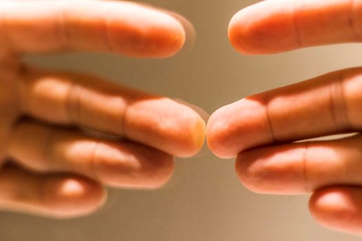 Close up shot of a hand's reflection in the mirror