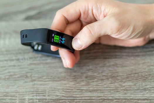 Close up shot of a man setting up a fitness wristband.