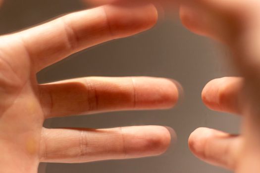 Close up shot of a hand's reflection in the mirror