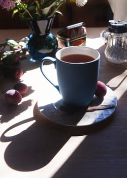Blue cup of tea in the bright morning light, morning tea concept, selective focus.
