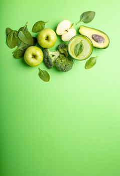Ingredients for making green healthy smoothie with broccoli, apples, avocado, spinach on pastel background, space for text. Clean eating, detox plan, diet, weight loss concept. Close up, top view