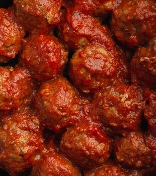 Close-up of delicious meatballs with tomato sauce, from above. Tasty homemade meatballs concept, food pattern background