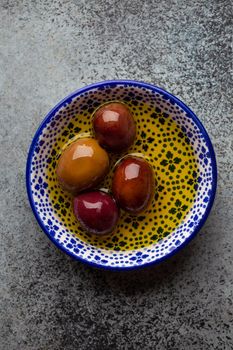 Delicious ripe black olives in a bowl, from above. Middle eastern and Mediterranean traditional snack or appetizer, light and healthy food, top view .