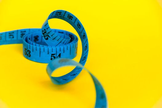 Blue measuring tape with customizable space for text or ideas. Copy space and weight loss concept.
