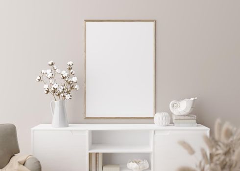 Empty vertical picture frame on cream wall in modern living room. Mock up interior in minimalist, scandinavian style. Free, copy space for picture. Console, armchair, cotton plant, vase. 3D rendering