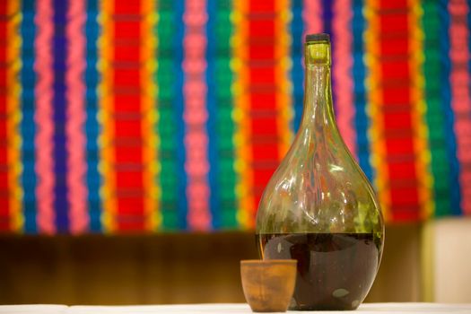 Wine bottle on the table with cup