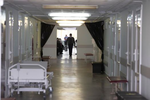 Hospital or polyclinic corridor with patients.