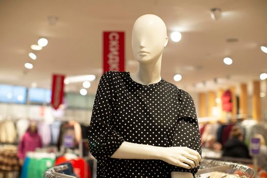 Mannequins in a clothing store in red and blue colors. Clothes sale.