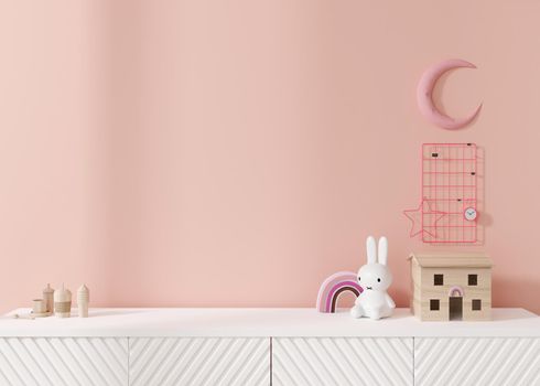 Empty pink wall. Mock up kids room interior in contemporary style. Close up view. Free, copy space for your picture or other small object. Sideboard, toys. 3D rendering. Child room mock-up