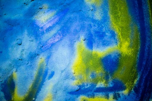 Background of multi-colored scattered sand.The colors of the Ukrainian flag are blue and yellow.