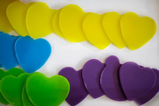 Multicolored figurines in the shape of a heart made of wax.