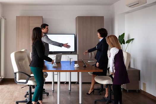 Business people discussing together in conference room during meeting at office. Professional team.