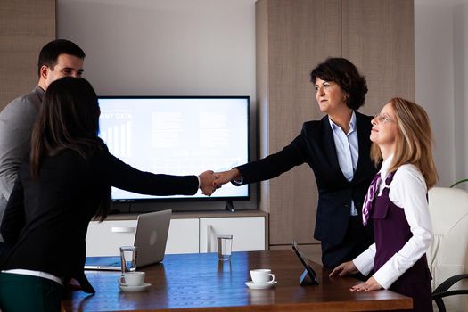 Business people discussing together in conference room during meeting at office. Professional team.