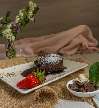 chocolate coulant with strawberries with flower background sweet dessert