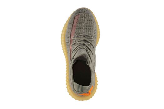 Gray rag sneaker isolated on white background. Cheap sports shoes.