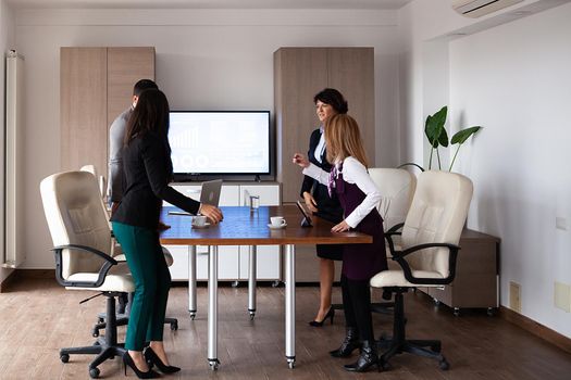 Business people discussing together in conference room during meeting at office. Professional team.