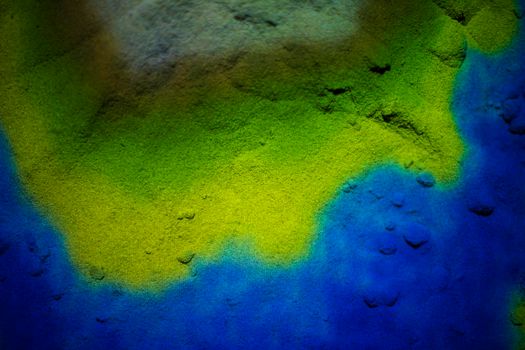 Background of multi-colored scattered sand.The colors of the Ukrainian flag are blue and yellow.