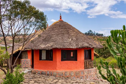 Beautiful colored traditional ethiopian house, hut situated in mountain landscape near Debre Libanos, Ethiopia, Africa.