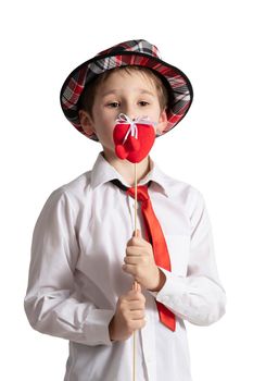 Funny little boy in an elegant hat with a valentine heart.