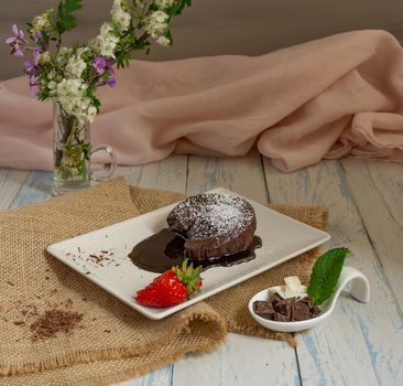 chocolate coulant with strawberries with flower background sweet dessert