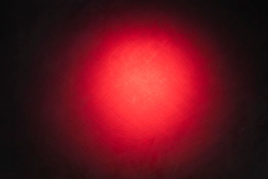 Red grunge background with a dark vignette and a light spot in the middle.