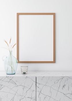 Empty vertical picture frame on white wall in modern living room. Mock up interior in minimalist, scandinavian style. Free space for picture. Marble console and dried grass in glass vase, 3D rendering