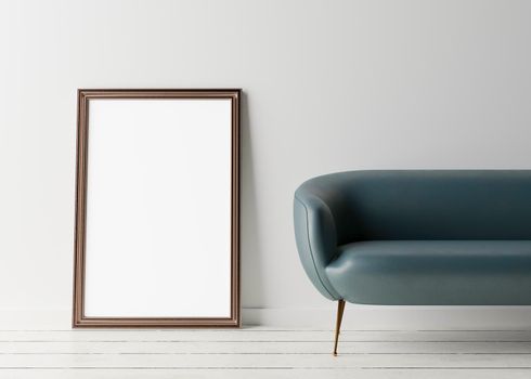 Empty vertical picture frame standing on the floor, with white wall and blue leather couch. Mock up interior in minimalist style. Free space, copy space for your picture or text. 3D rendering